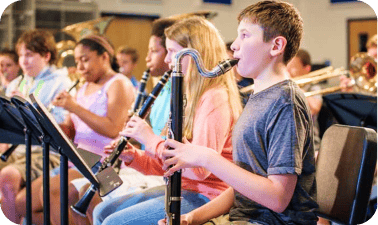 A photo of a student playing a rented instrument.